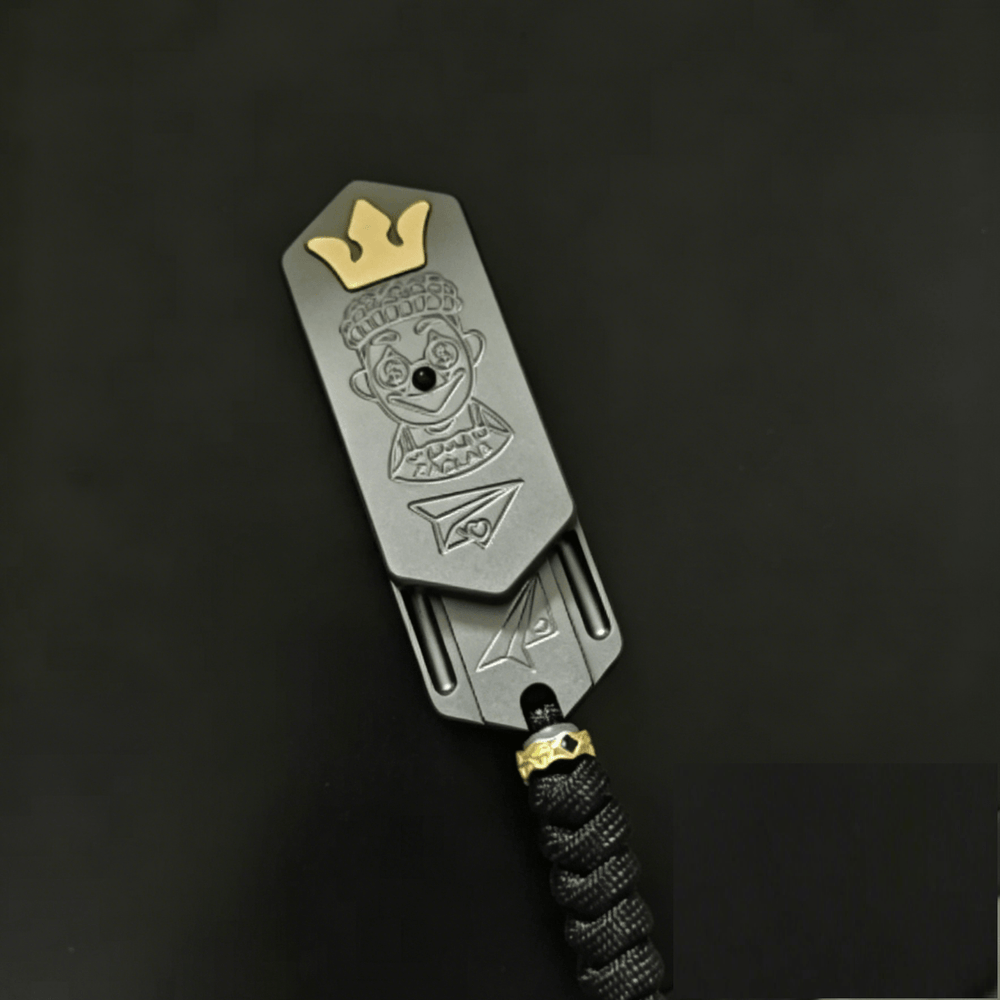 Lucky Candy Tuning Fork EDC Push Slider with crown design and detailed engraving on a dark background.