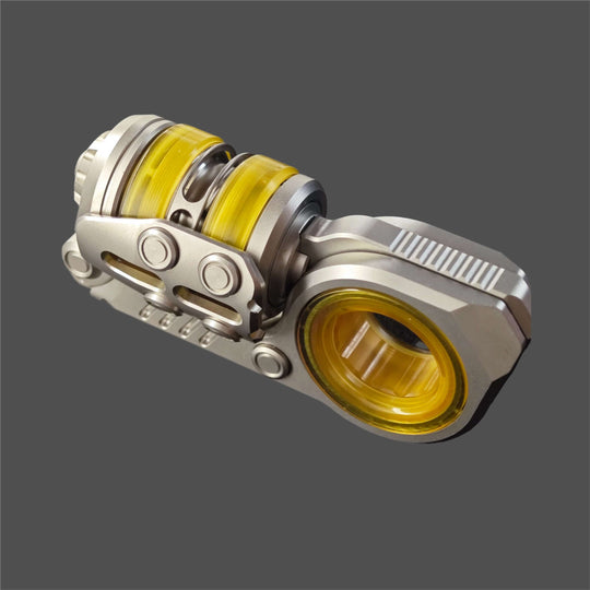Swing Ball Composite Tuning Fork Ratchet EDC featuring a stainless steel body and titanium alloy core with yellow accents.